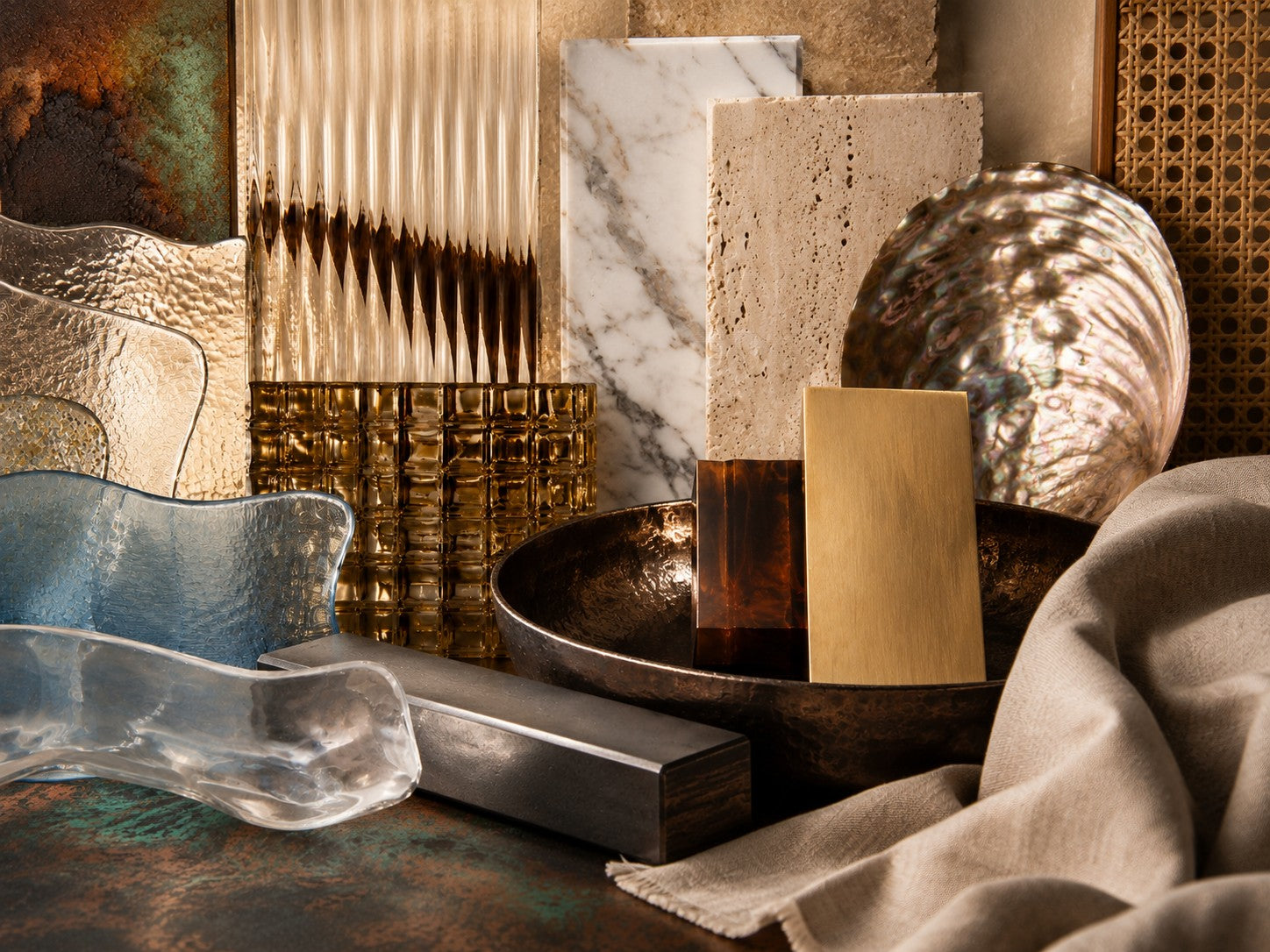 Glass, stone, metal, fabric, shell and rattan materials arranged together