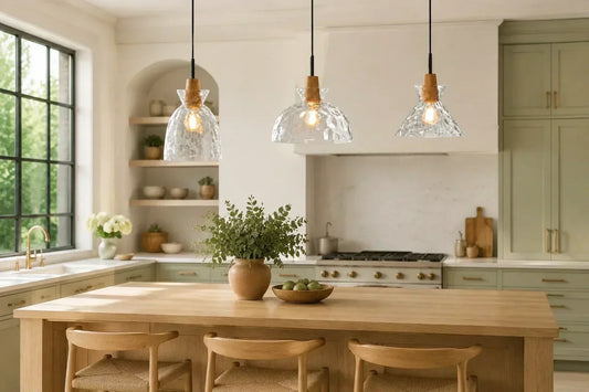 Three hammered glass pendant lights above a pale oak kitchen island