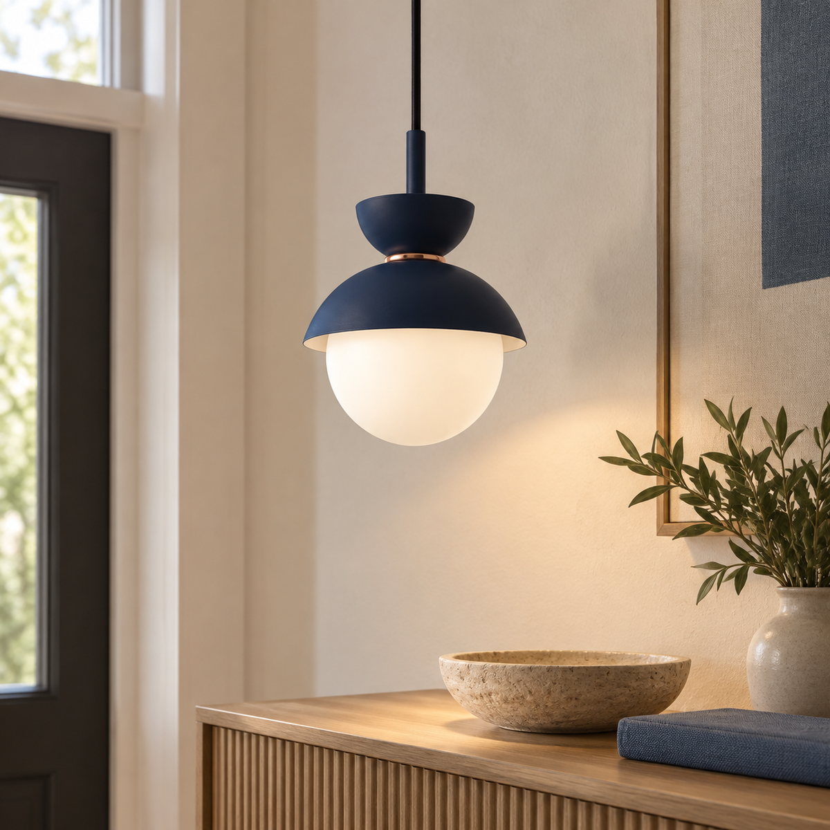 Navy blue Zosia pendant above an entry console