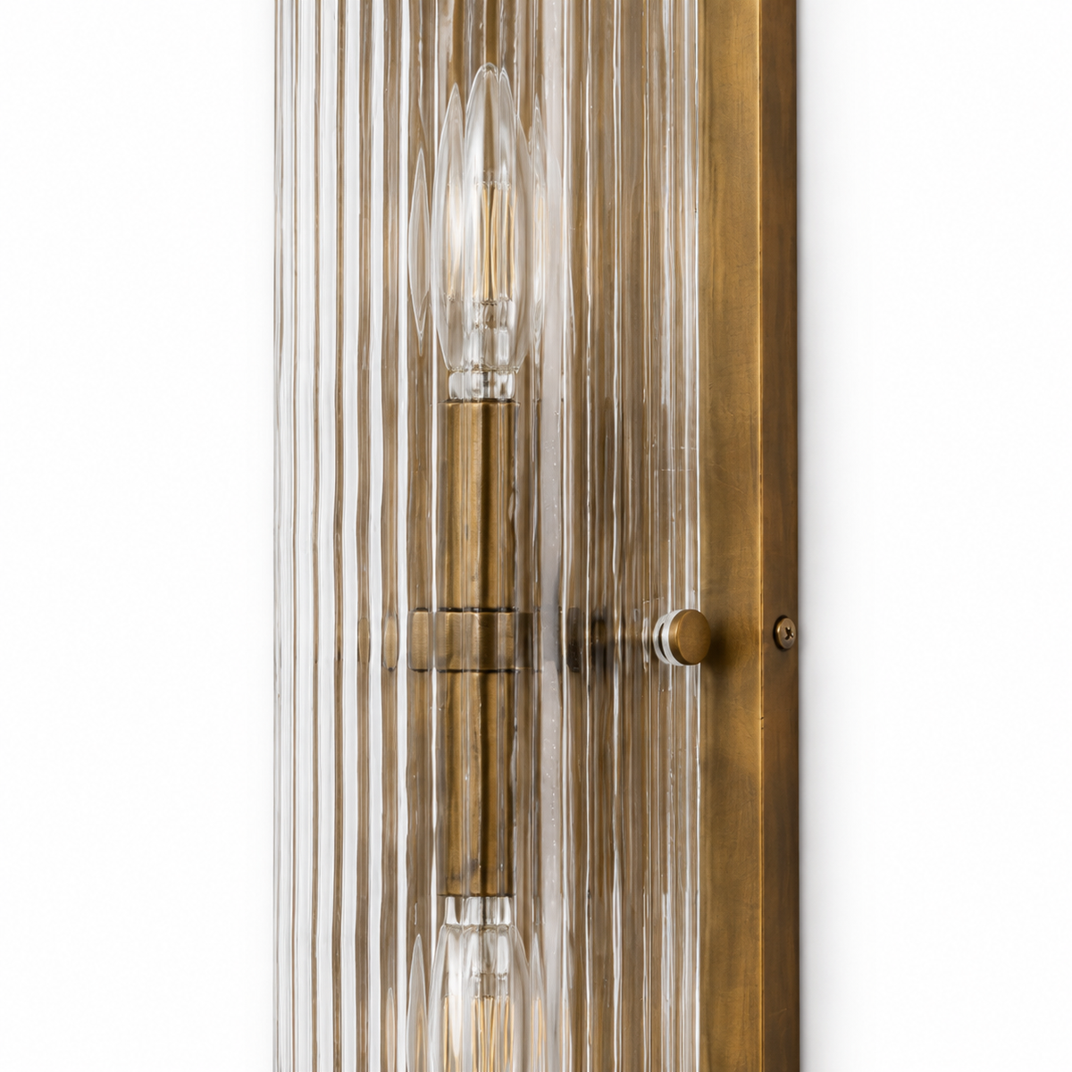 Close detail of an E12 bulb behind Kiera's reeded glass