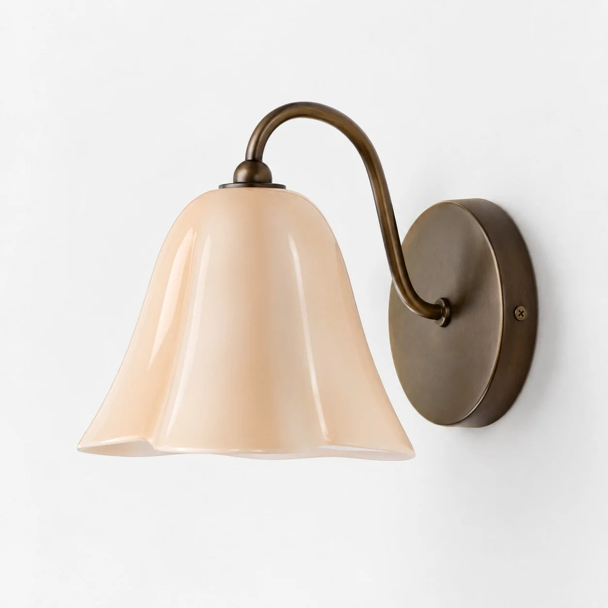 Complete Blush Nikolas seashell glass wall sconce on a white background