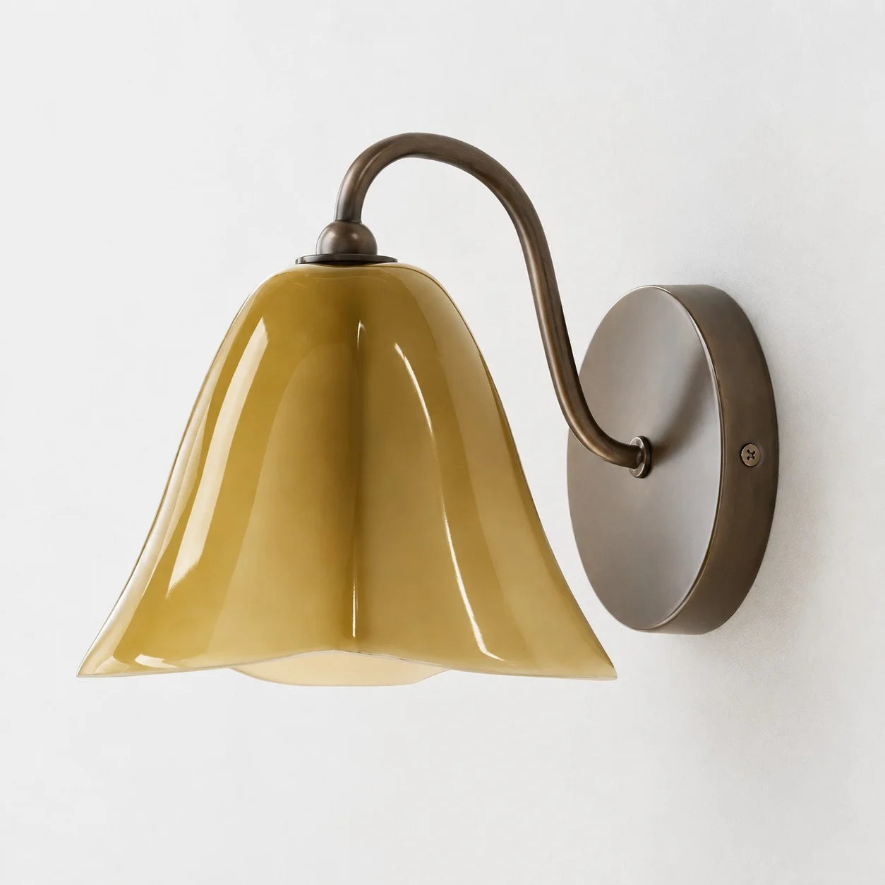 Complete Goldenrod Nikolas seashell glass wall sconce on a white background