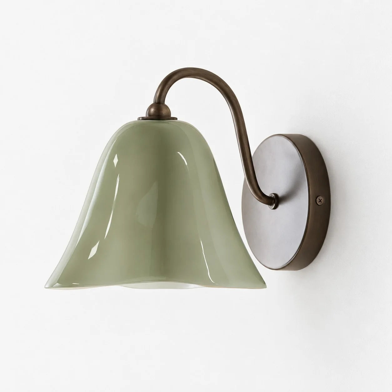 Complete Green Nikolas seashell glass wall sconce on a white background