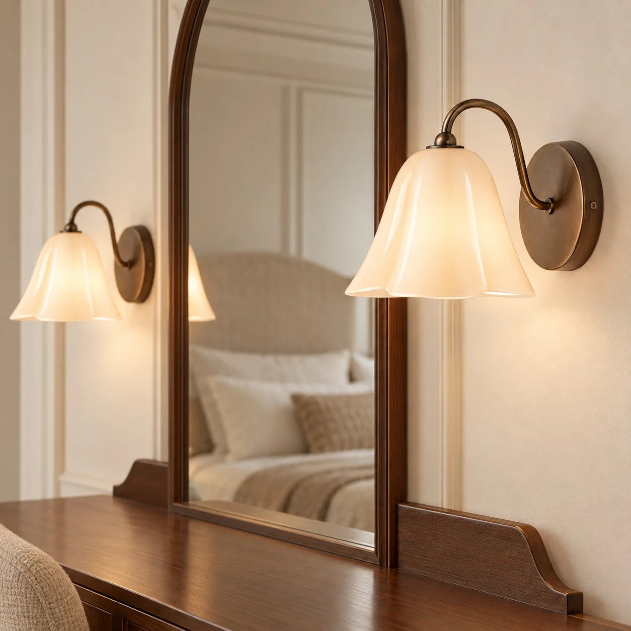 Blush Nikolas sconces around a bedroom mirror