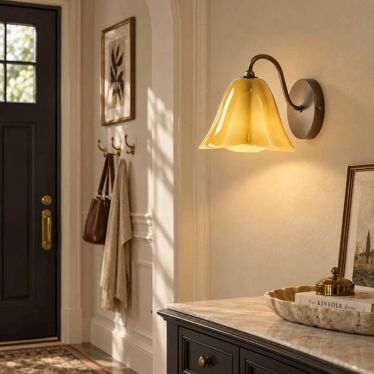 Goldenrod Nikolas wall sconce in an entryway
