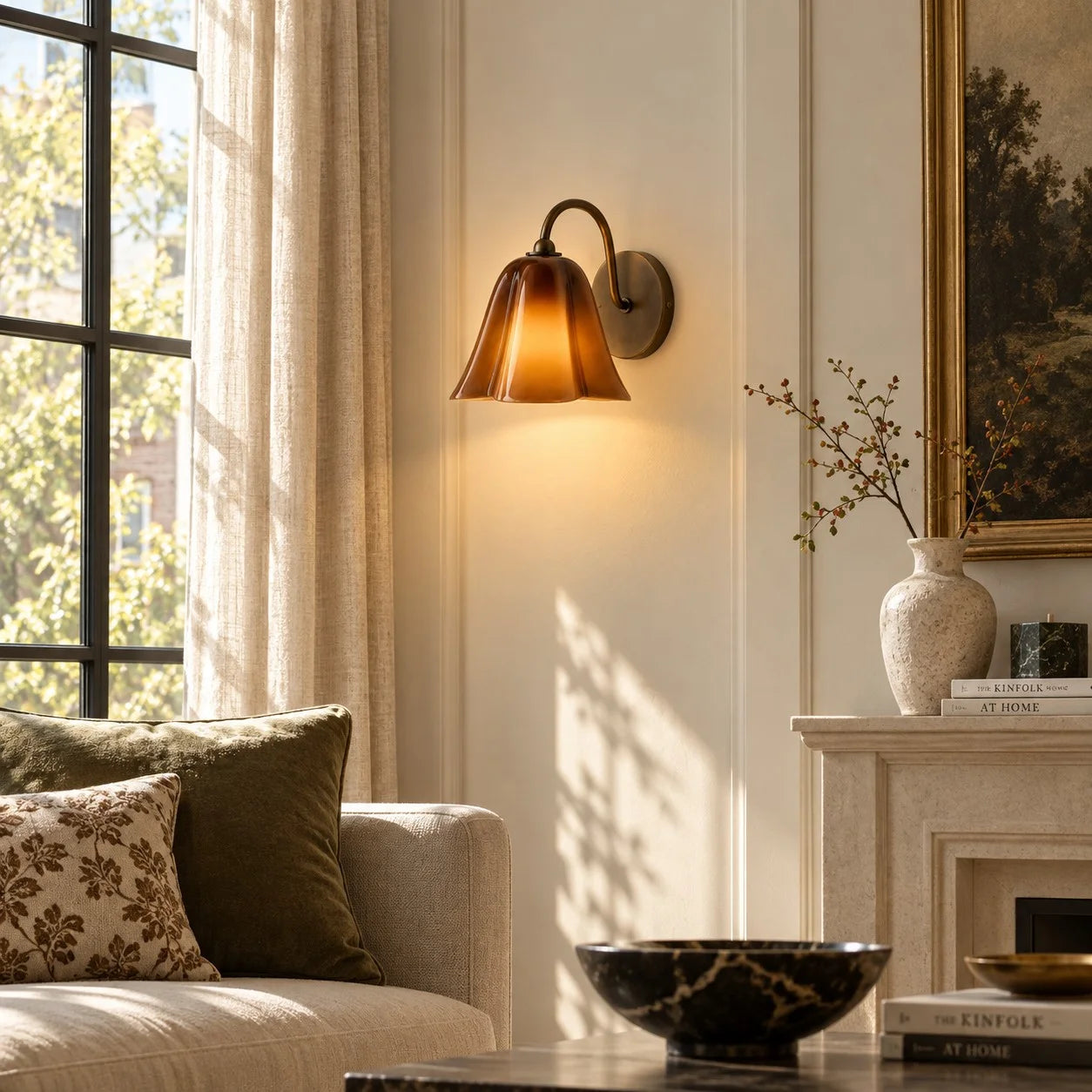 Amber Nikolas seashell glass wall sconce beside a living room window