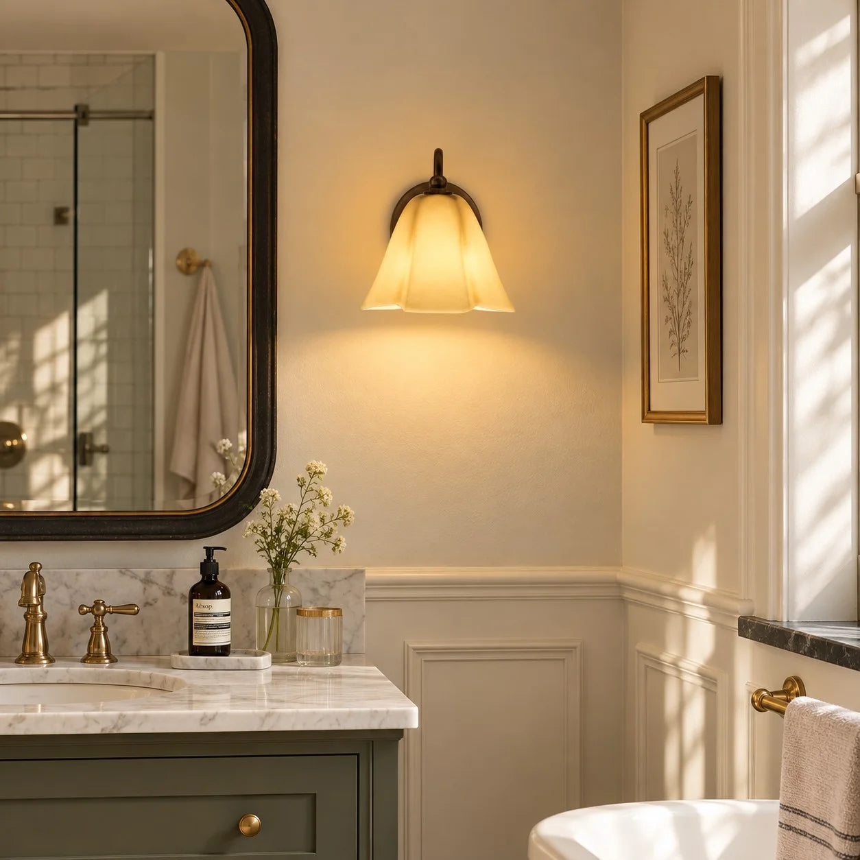 Blush Nikolas wall sconce above a bathroom vanity