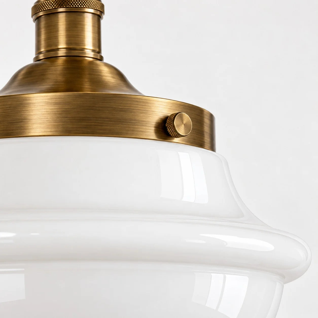 Close-up of the milk glass shade and warm-toned metal fitter