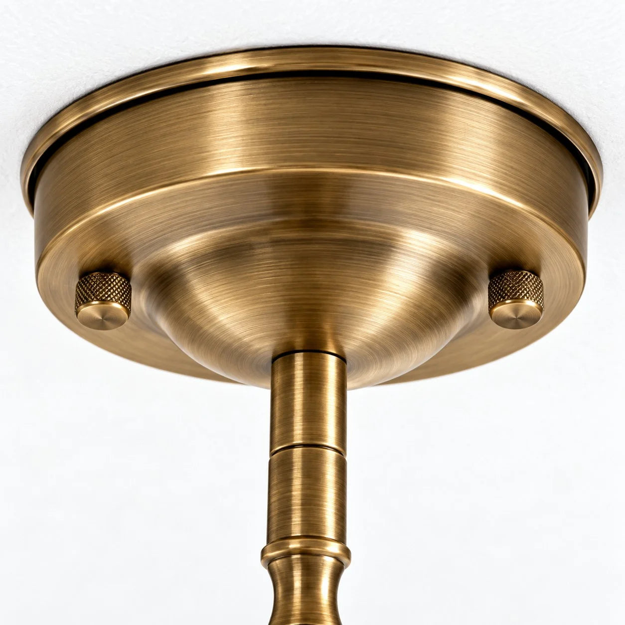 Close-up of the round warm-toned metal ceiling canopy