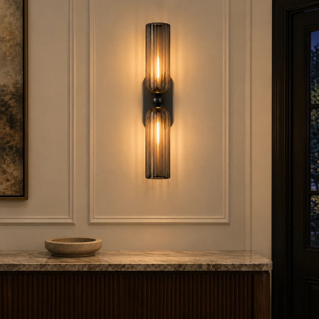 Anselm Mid-Century Ribbed Glass Double Tube Sconce, Black glowing over an entry console at night