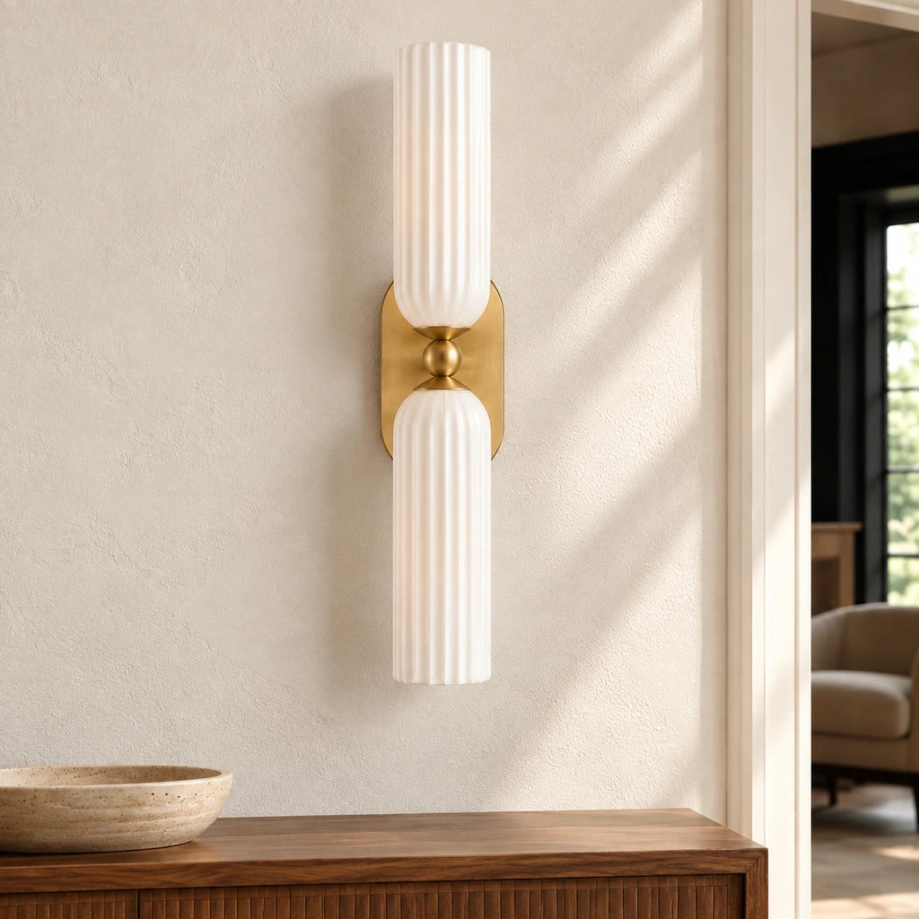 Anselm Mid-Century Ribbed Glass Double Tube Sconce, White switched off above a living room sideboard