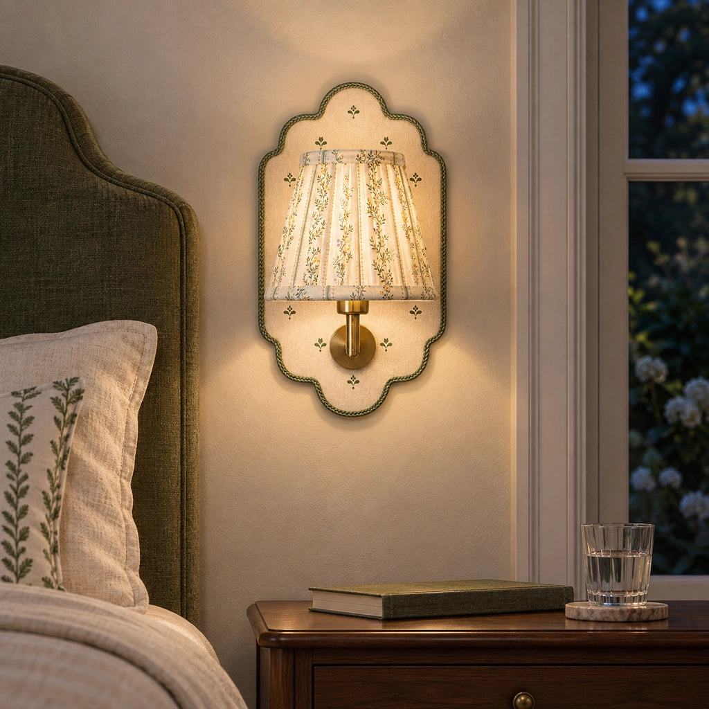 Maribel Vintage Floral Fabric Wall Sconce, warmly illuminated beside a bedside table at night