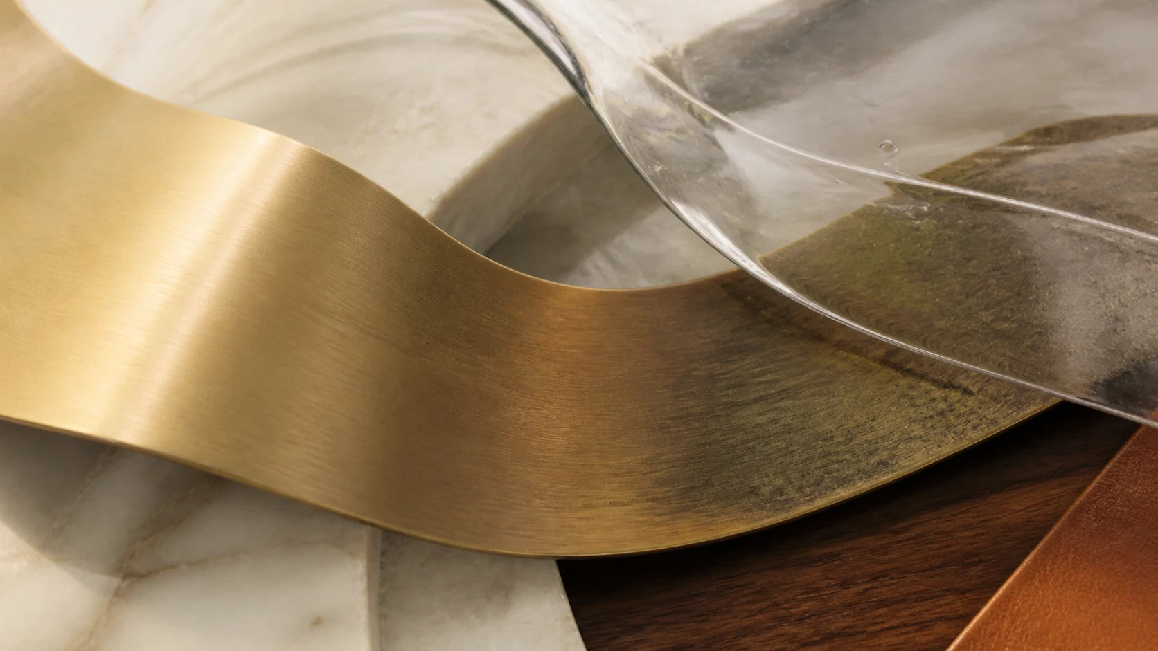Brushed unlacquered brass transitioning naturally into a deeper patina beneath hand-blown glass.
